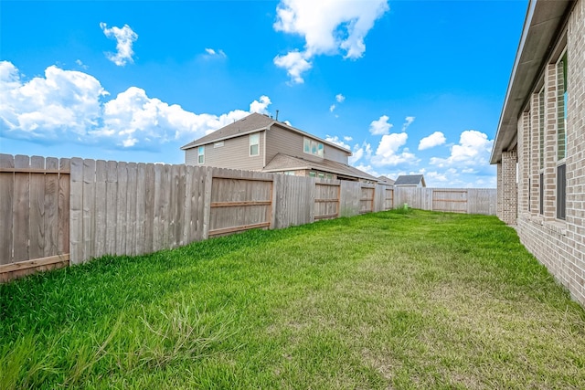 view of yard with a fenced backyard