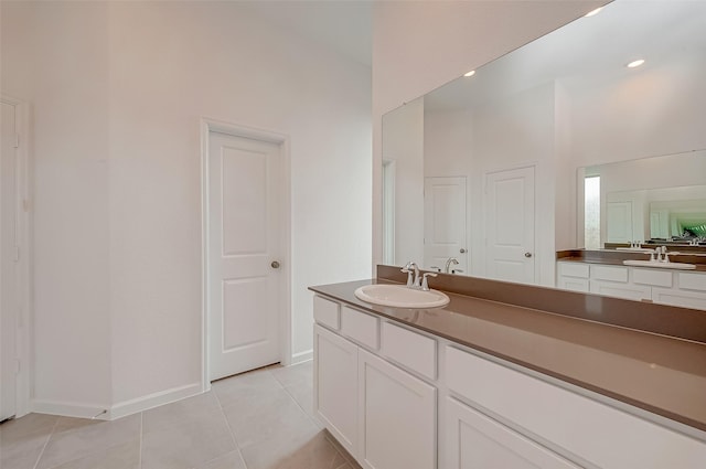 full bathroom with tile patterned floors, vanity, and baseboards
