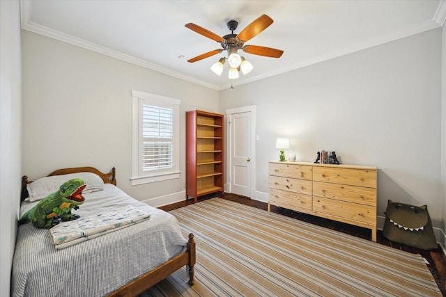 bedroom featuring ornamental molding, baseboards, ceiling fan, and wood finished floors