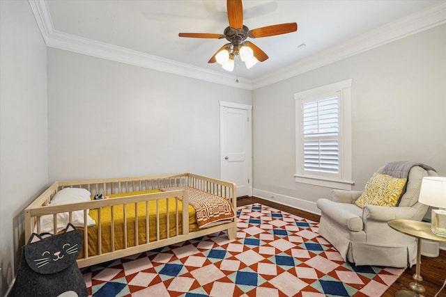 bedroom featuring baseboards, ornamental molding, and a ceiling fan