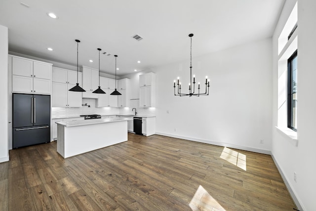kitchen featuring a chandelier, light countertops, visible vents, dishwasher, and high quality fridge