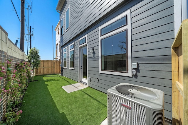 exterior space with a fenced backyard and cooling unit