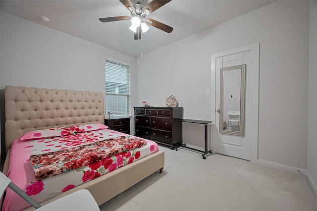 bedroom featuring light colored carpet, baseboards, and ceiling fan