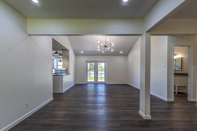 652 E Taylor Lake Cir, Livingston, TX 77351 - unfurnished living room featuring dark wood-type flooring, french doors, baseboards, and lofted ceiling