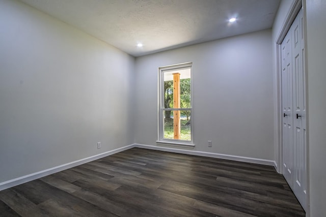 652 E Taylor Lake Cir, Livingston, TX 77351 - empty room featuring dark wood-style flooring, baseboards, and recessed lighting