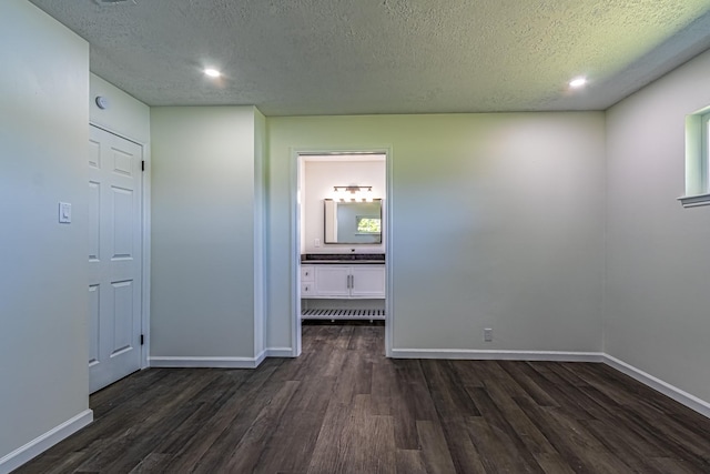 652 E Taylor Lake Cir, Livingston, TX 77351 - spare room featuring a textured ceiling, baseboards, and dark wood finished floors