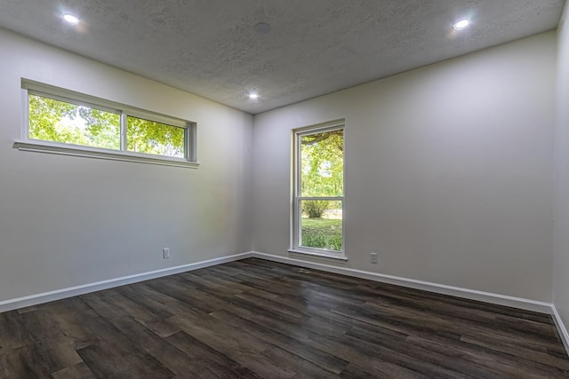 652 E Taylor Lake Cir, Livingston, TX 77351 - unfurnished room featuring a textured ceiling, baseboards, dark wood-style floors, and recessed lighting