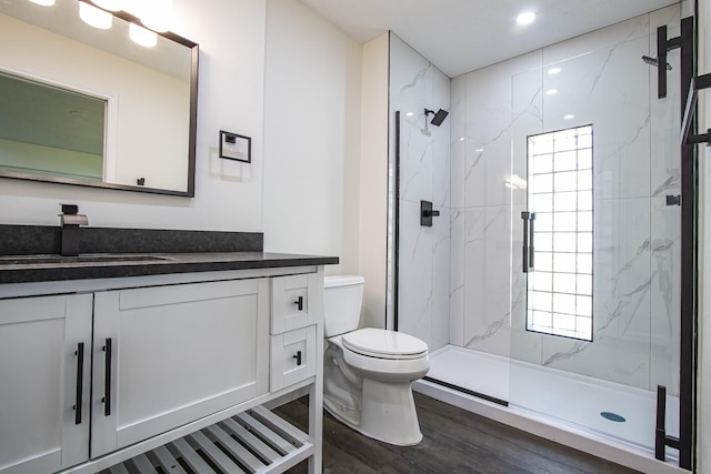 652 E Taylor Lake Cir, Livingston, TX 77351 - full bath with plenty of natural light, toilet, vanity, wood finished floors, and a marble finish shower