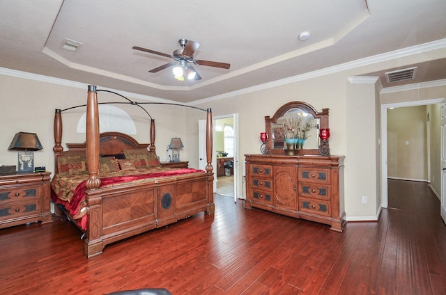 25419 Richton Falls Dr, Richmond, TX 77406 - bedroom featuring visible vents, baseboards, a tray ceiling, and hardwood / wood-style floors