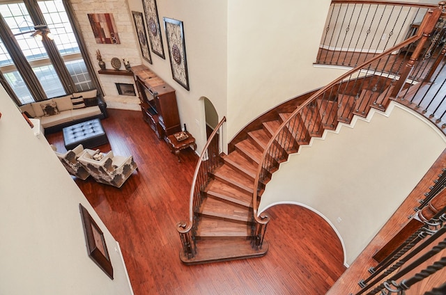 25419 Richton Falls Dr, Richmond, TX 77406 - stairs with arched walkways, wood finished floors, and a high ceiling