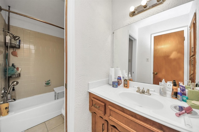 13230 Ferry Hill Ln, Houston, TX 77015 - bathroom featuring tile patterned flooring, vanity, shower / bathtub combination, and a textured wall