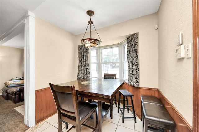 13230 Ferry Hill Ln, Houston, TX 77015 - dining space with a wainscoted wall, light tile patterned floors, and wood walls