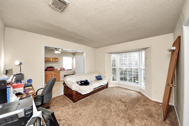 13230 Ferry Hill Ln, Houston, TX 77015 - carpeted bedroom with multiple windows, a textured ceiling, an office area, and baseboards