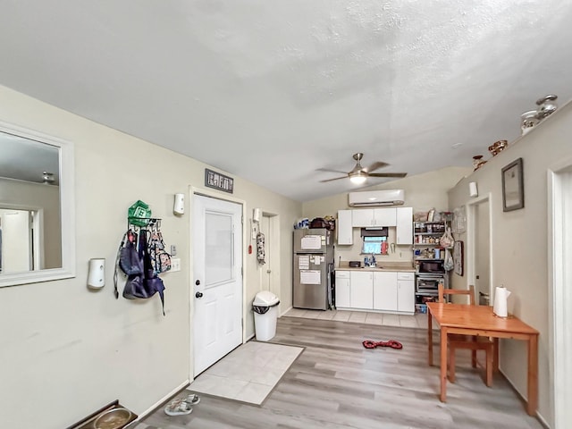 13230 Ferry Hill Ln, Houston, TX 77015 - entryway with an AC wall unit, light wood-style flooring, and ceiling fan