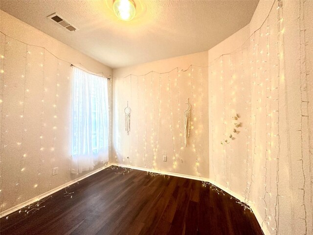 8414 Manassas Ln, Houston, TX 77083 - unfurnished room featuring wood finished floors, a textured ceiling, and baseboards