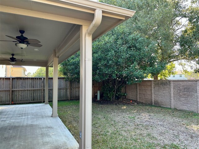 8414 Manassas Ln, Houston, TX 77083 - fenced backyard with ceiling fan and a patio area