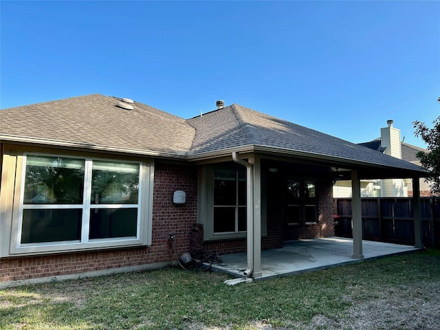 8414 Manassas Ln, Houston, TX 77083 - rear view of property featuring a patio, brick siding, roof with shingles, and a chimney