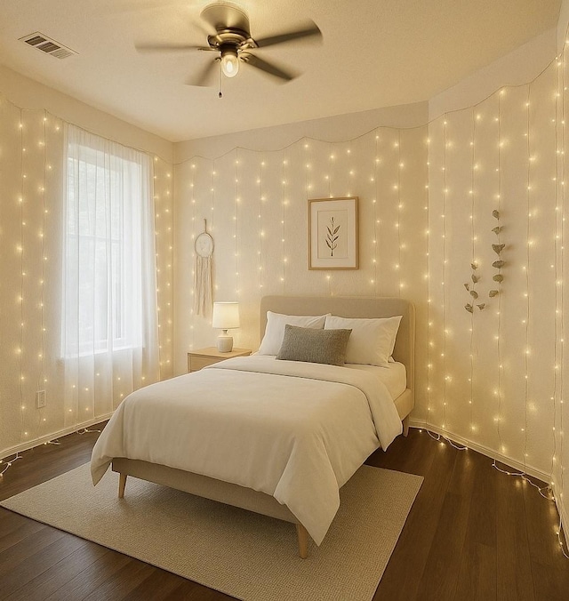 bedroom featuring wood finished floors and ceiling fan