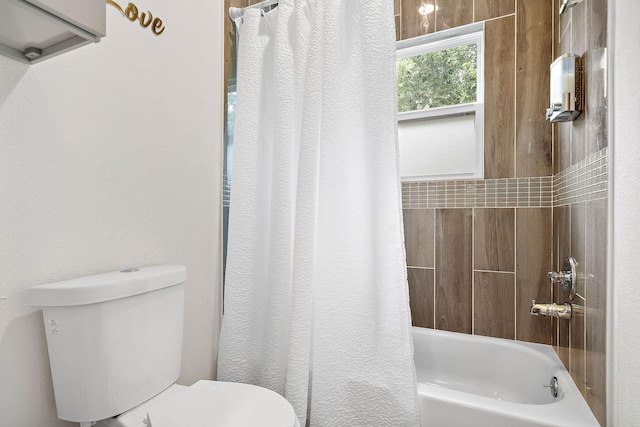 bathroom featuring shower / bathtub combination with curtain and toilet