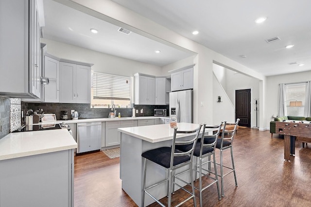 kitchen featuring visible vents, stainless steel appliances, a healthy amount of sunlight, and a sink