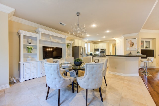 dining area with light tile patterned flooring, visible vents, ornamental molding, and a notable chandelier