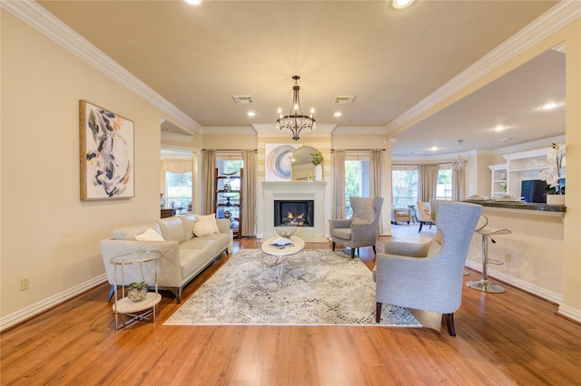 living room featuring visible vents, wood finished floors, an inviting chandelier, and recessed lighting