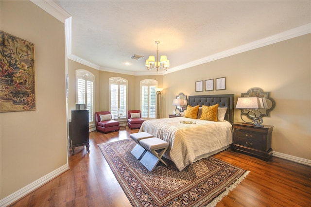 bedroom with an inviting chandelier, visible vents, baseboards, ornamental molding, and wood finished floors
