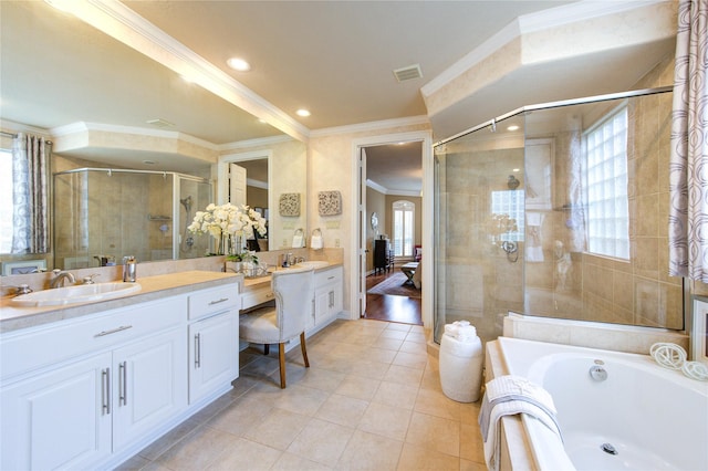 bathroom featuring crown molding, a stall shower, tile patterned floors, a garden tub, and vanity