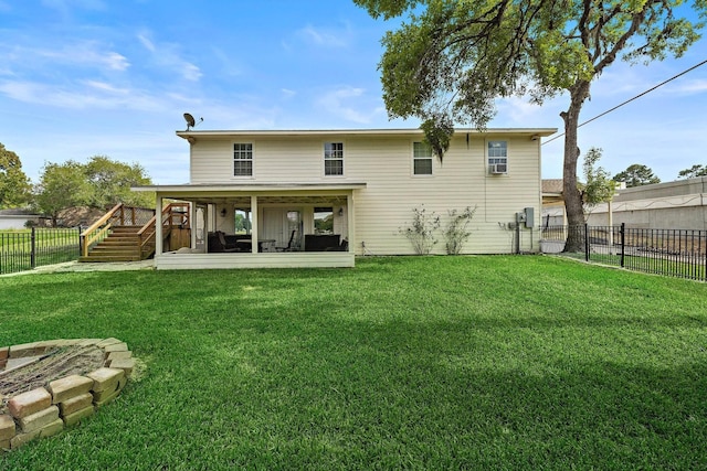 rear view of property with a fenced backyard, stairs, a wooden deck, and a lawn