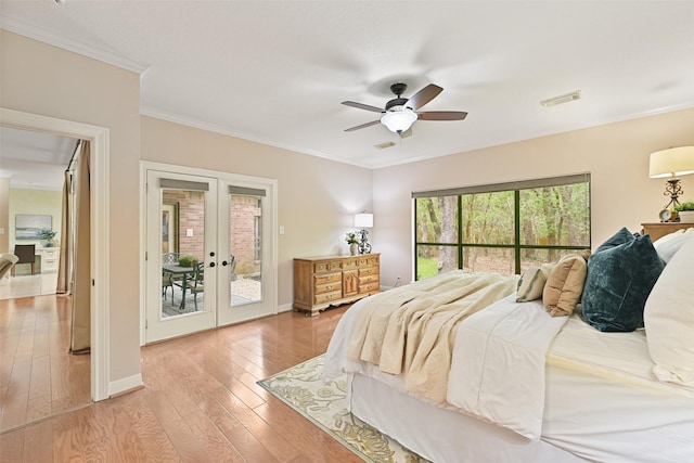 bedroom with access to outside, french doors, crown molding, light wood-style floors, and visible vents