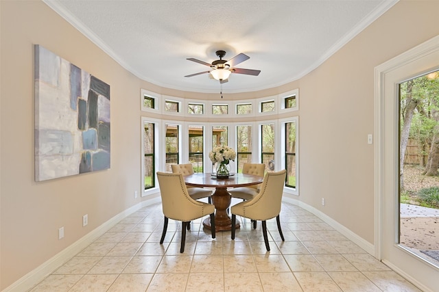 dining space featuring light tile patterned floors, baseboards, crown molding, and ceiling fan
