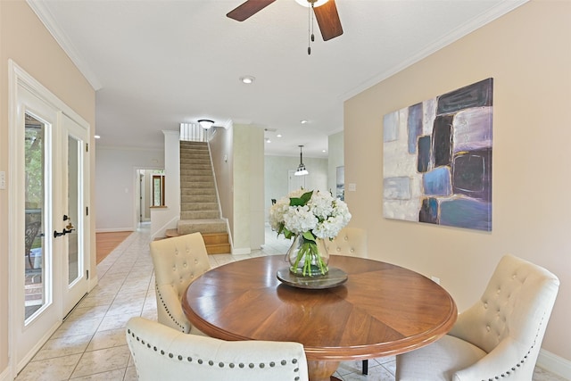 dining area with baseboards, stairway, light tile patterned floors, crown molding, and a ceiling fan