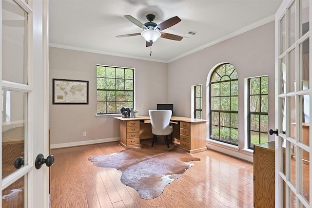 office area featuring baseboards, french doors, crown molding, a ceiling fan, and light wood finished floors