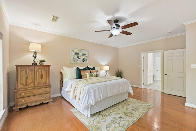 bedroom with visible vents, baseboards, ornamental molding, light wood-type flooring, and a ceiling fan