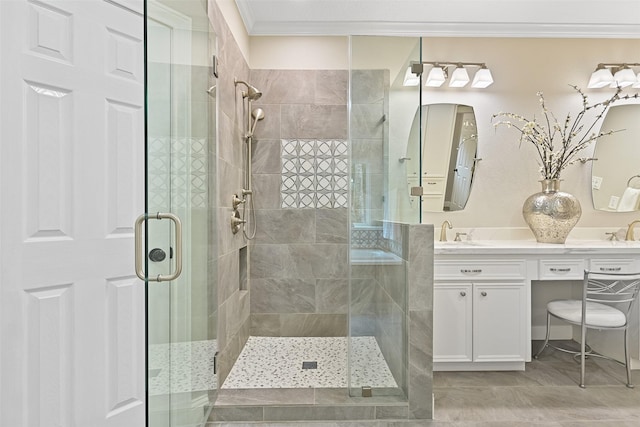 full bath with crown molding, a shower stall, double vanity, and a sink
