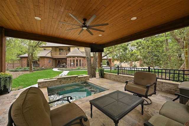 view of patio featuring fence, a ceiling fan, an outdoor living space, and a balcony