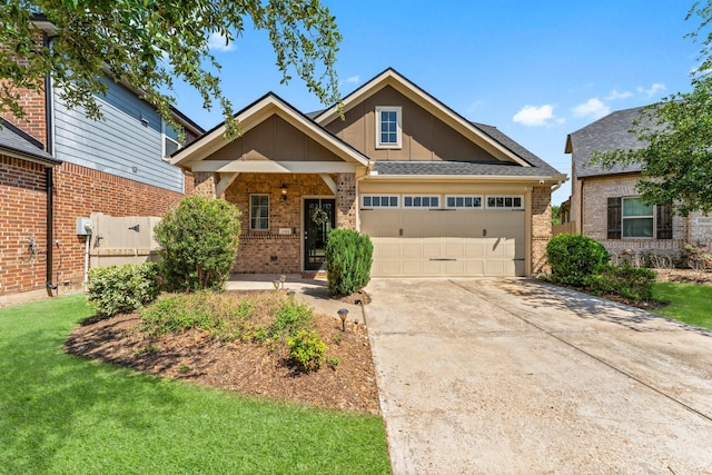 view of front of house with concrete driveway, brick siding, a front lawn, and an attached garage