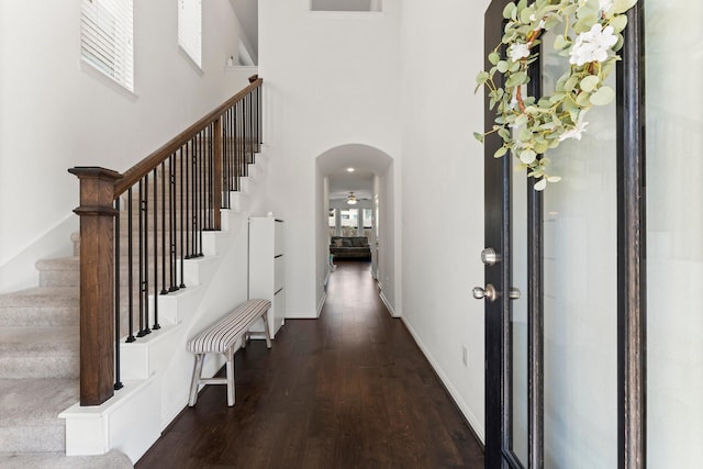 1504 Summer City Dr, Houston, TX 77047 - entryway featuring arched walkways, wood finished floors, stairway, a high ceiling, and baseboards