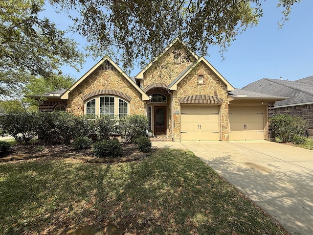 29046 Davenport Dr, Katy, TX 77494 - view of front of house with a garage, concrete driveway, a front lawn, and stone siding