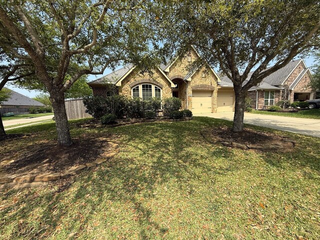 29046 Davenport Dr, Katy, TX 77494 - view of front of property with driveway, a front yard, a garage, brick siding, and fence