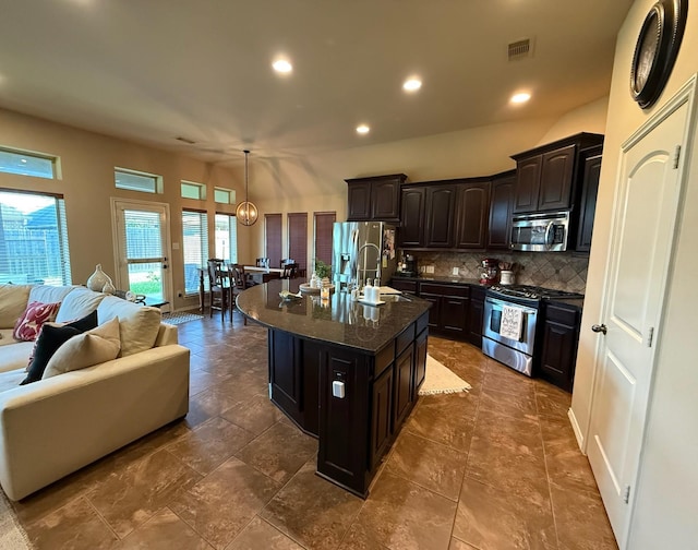29046 Davenport Dr, Katy, TX 77494 - kitchen with decorative backsplash, visible vents, appliances with stainless steel finishes, a sink, and open floor plan