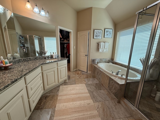29046 Davenport Dr, Katy, TX 77494 - bathroom featuring a walk in closet, vanity, a shower stall, vaulted ceiling, and a bath