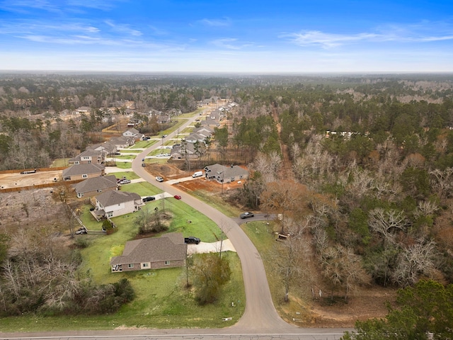 drone / aerial view with a residential view and a forest view