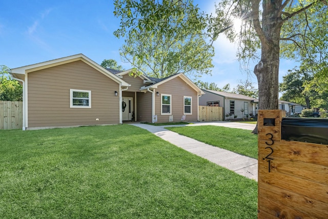 single story home featuring a front yard and fence