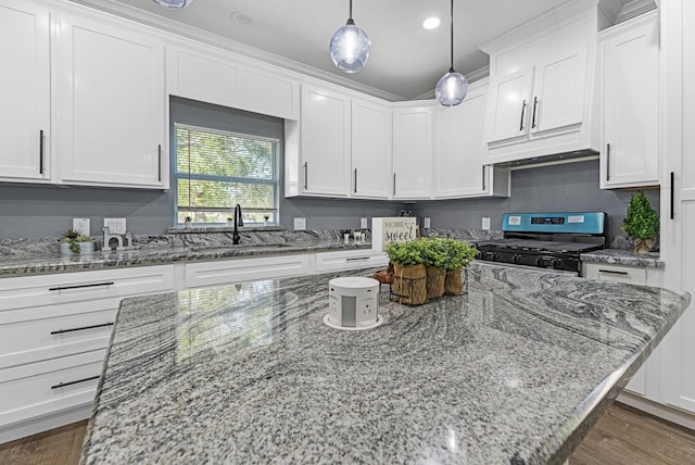 kitchen featuring white cabinets, a sink, and gas stove