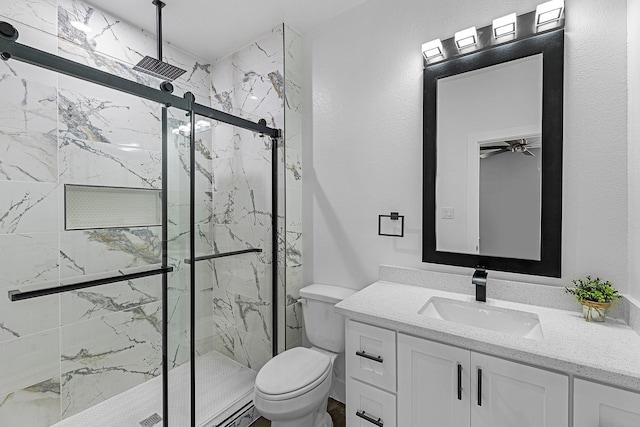 full bath with a marble finish shower, toilet, ceiling fan, and vanity