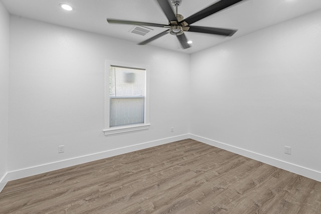 spare room featuring visible vents, recessed lighting, and wood finished floors
