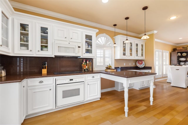 kitchen with white cabinets, white appliances, and dark countertops