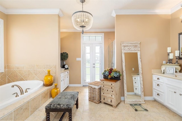 bathroom featuring a bath, ornamental molding, baseboards, and a notable chandelier