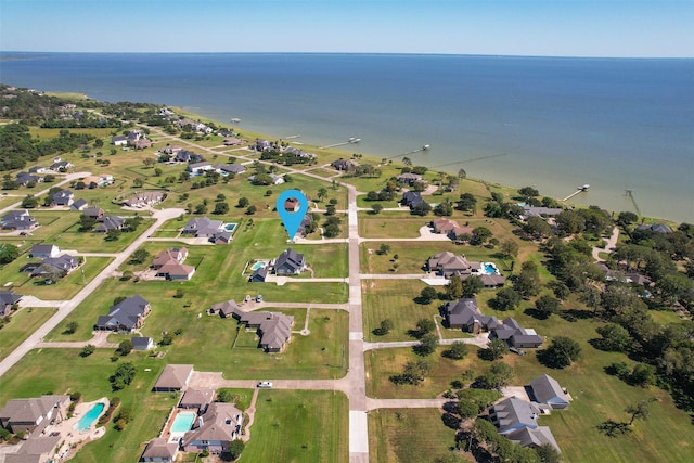 drone / aerial view with a water view and a residential view